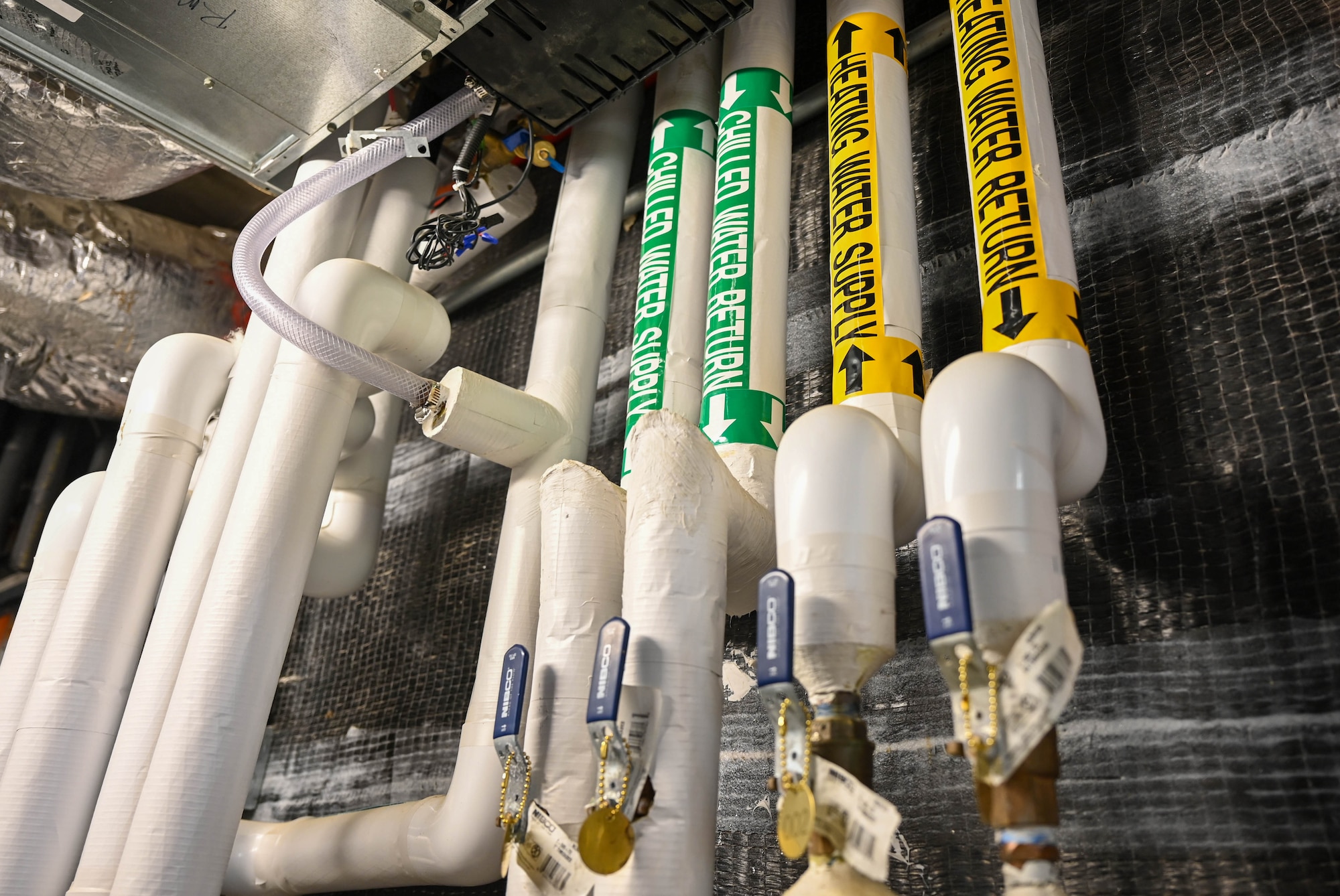 Plumbing infrastructure is attached to a wall.