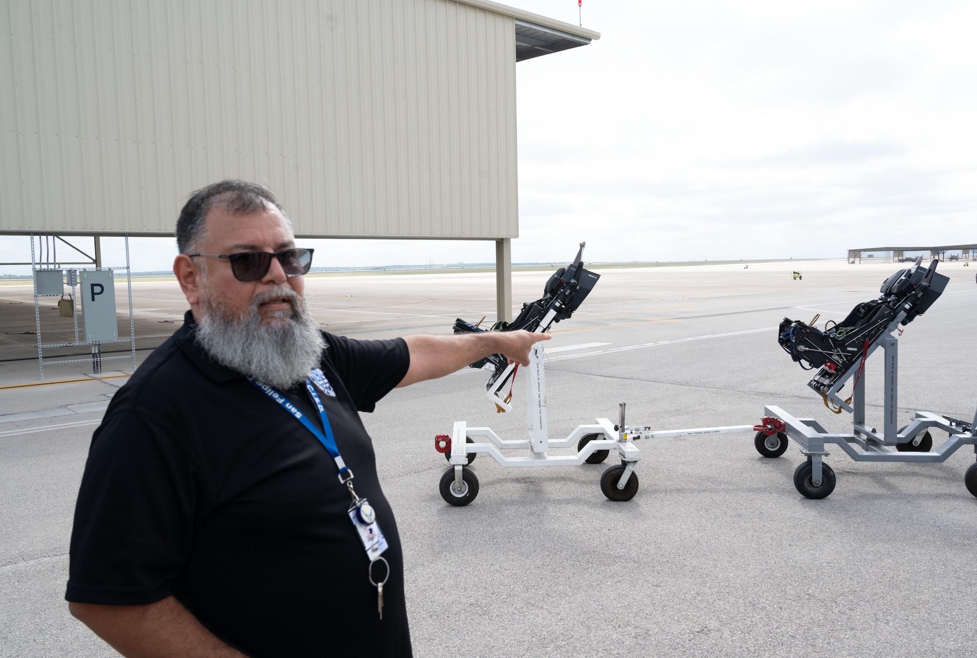 Abraham Herrera, Del Rio High School Career and Technical Education (CTE) aircraft maintenance instructor, points out the key features of an aircraft ejection seat on the flight line during a CTE tour at Laughlin Air Force Base, Texas, May 5, 2026. Herrera explained the importance of safety and knowledge of all aircraft systems during a tour hosted for Del Rio Middle School students in conjunction with the Laughlin School Liaison office. (U.S. Air Force photo by Joseph Pagan)
