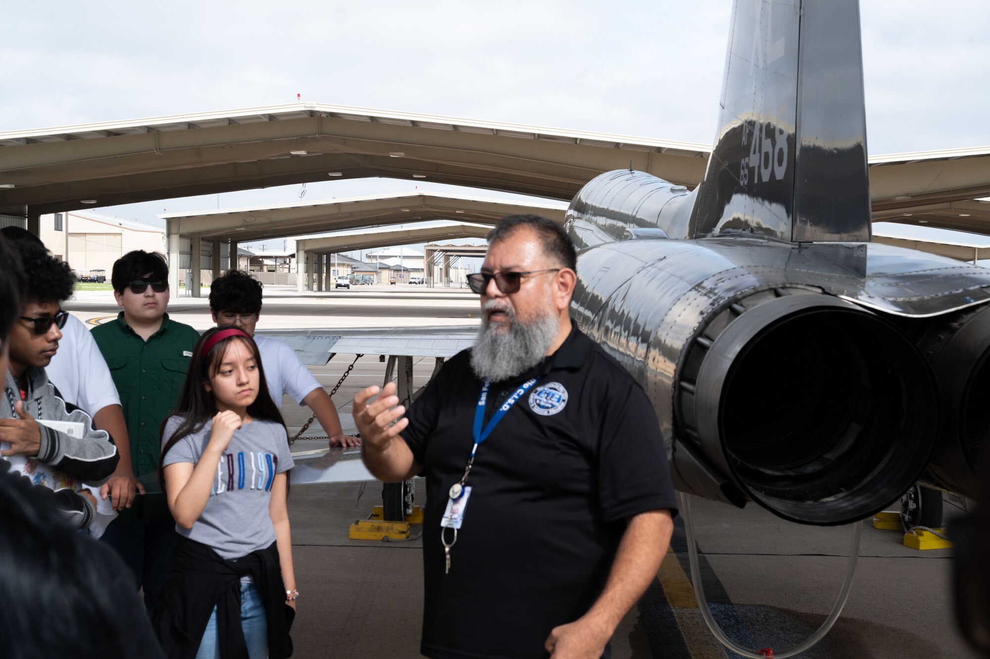 Abraham Herrera, Del Rio High School Career and Technical Education aircraft maintenance instructor, and students from Del Rio Middle school stand in front of a T-38C Talon afterburner engine on the flightline at Laughlin Air Force Base, Texas, May 5, 2026. Herrera explained to students from the UT Austin Gaining Early Awareness and Readiness for Undergraduate Program (GEAR UP) about T-38C aircraft technology, critical aviation safety procedures and the importance of readiness as a pilot and a maintainer. (U.S. Air Force photo by Joseph Pagan)