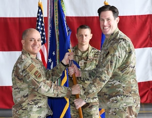 Air Force Colonel gives 55th Wing guidon to new 55th Wing command chief