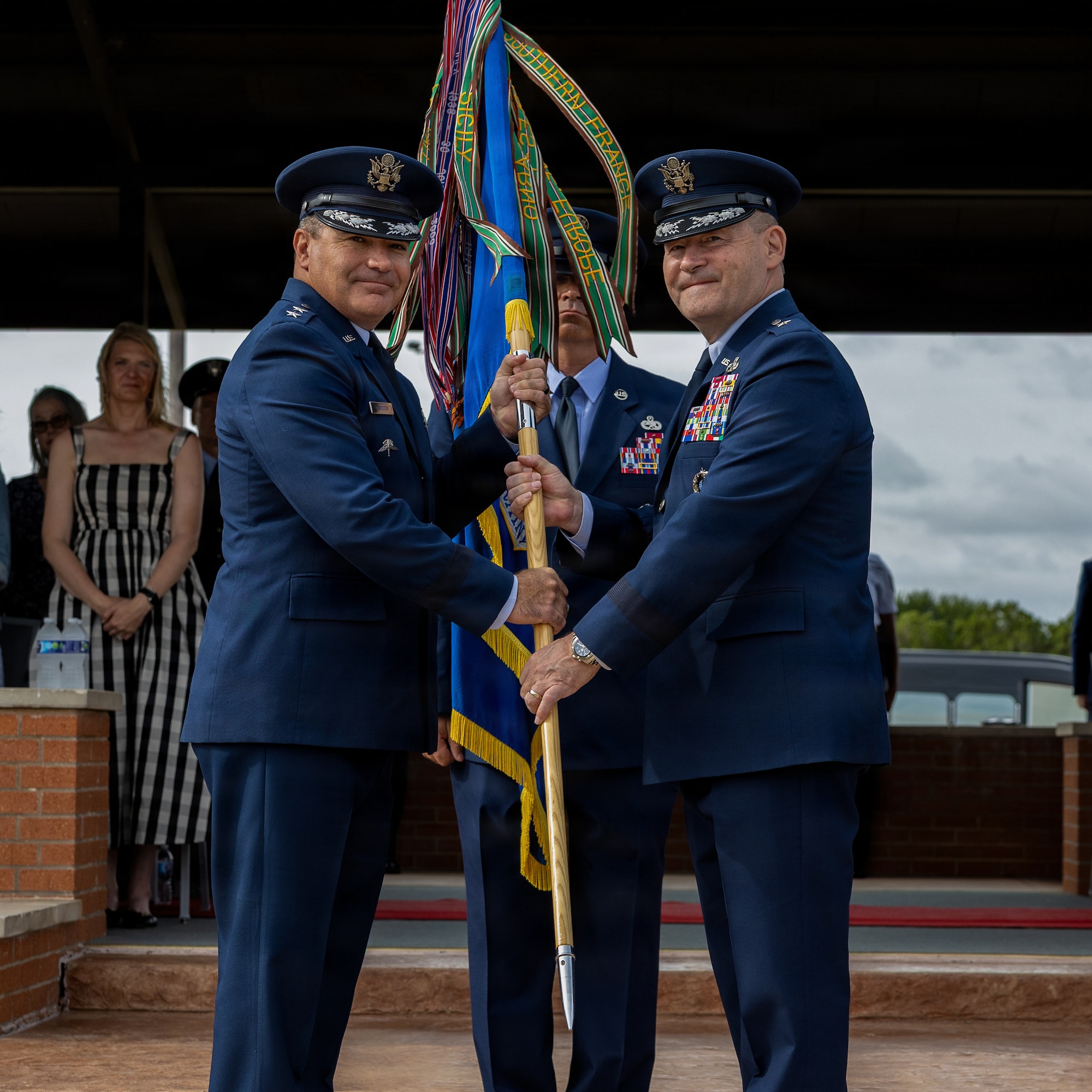 From left, U.S. Air Force Maj. Gen. Wolfe Davidson, Second Air Force commander, receives the guidon from U.S. Air Force Brig. Gen. Paul Filcek, 82nd Training Wing and installation outgoing commander, during the 82nd TRW change of command ceremony at Sheppard Air Force Base, Texas, June 5, 2026.
