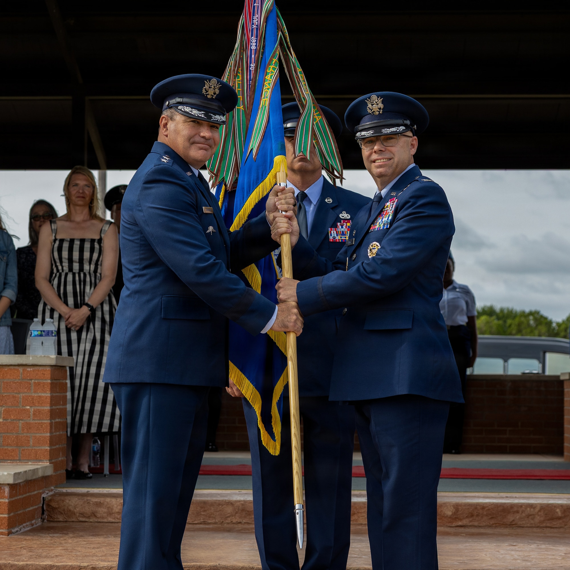 From left, U.S. Air Force Maj. Gen. Wolfe Davidson, Second Air Force commander, presents the guidon to U.S. Air Force Col. Samuel Mink, 82nd Training Wing and installation incoming commander, during the 82nd TRW change of command ceremony at Sheppard Air Force Base, Texas, June 5, 2026.