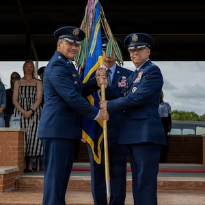 From left, U.S. Air Force Maj. Gen. Wolfe Davidson, Second Air Force commander, presents the guidon to U.S. Air Force Col. Samuel Mink, 82nd Training Wing and installation incoming commander, during the 82nd TRW change of command ceremony at Sheppard Air Force Base, Texas, June 5, 2026.
