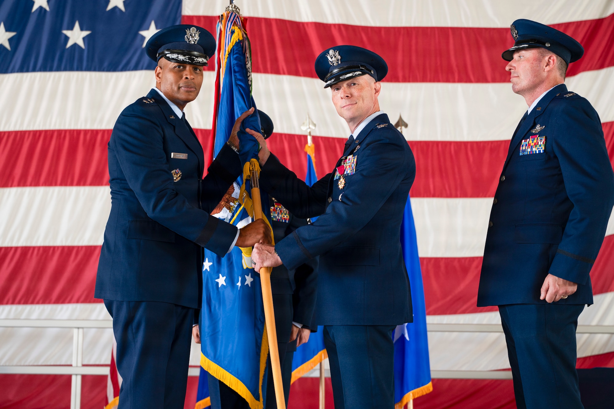 U.S. Air Force Col. John Ethridge, right, relinquishes command of the 49th Wing, to Maj. Gen. Roy W. Collins, Air Education and Training Command deputy commander, during a change of command ceremony at Holloman Air Force Base, New Mexico, June 4, 2026. The change of command ceremony is an American military tradition deeply rooted in history, signifying the authority of the incoming commander. (U.S. Air Force photo by Senior Airman Michelle Ferrari)