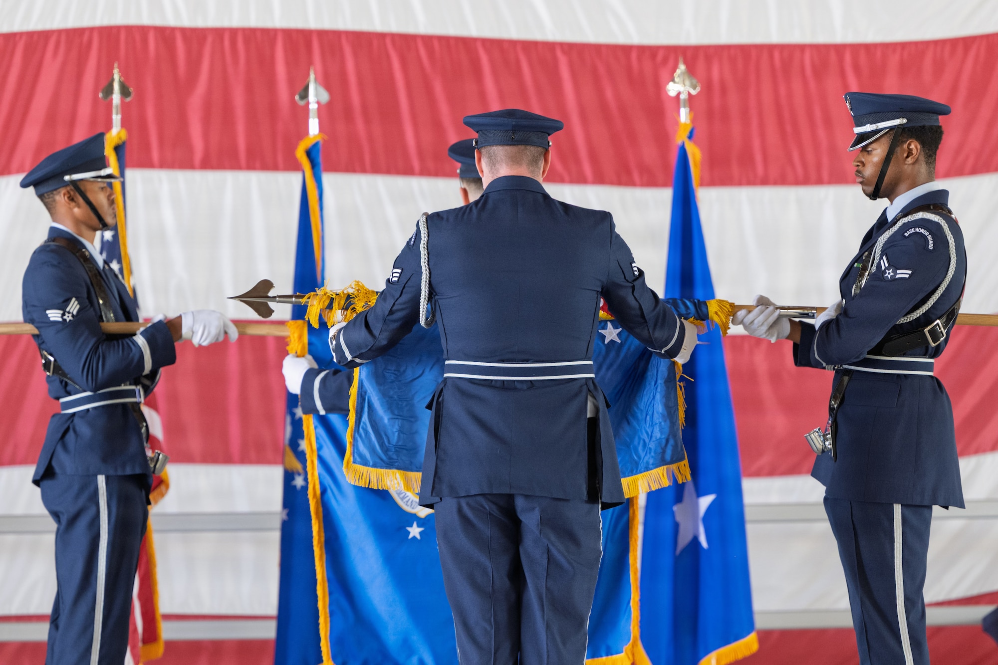 Members of the Steel Talons Honor Guard unfurl the Air Combat Command flag during the 49th Wing change of command and major command reassignment ceremony at Holloman Air Force Base, New Mexico, June 4, 2026. The 49th Wing has been reassigned to Air Combat Command, optimizing training pipelines for Airmen at the primary F-16 Fighting Falcon and MQ-9 Reaper schoolhouse in the Air Force. (U.S. Air Force photo by Airman Jose Veras)