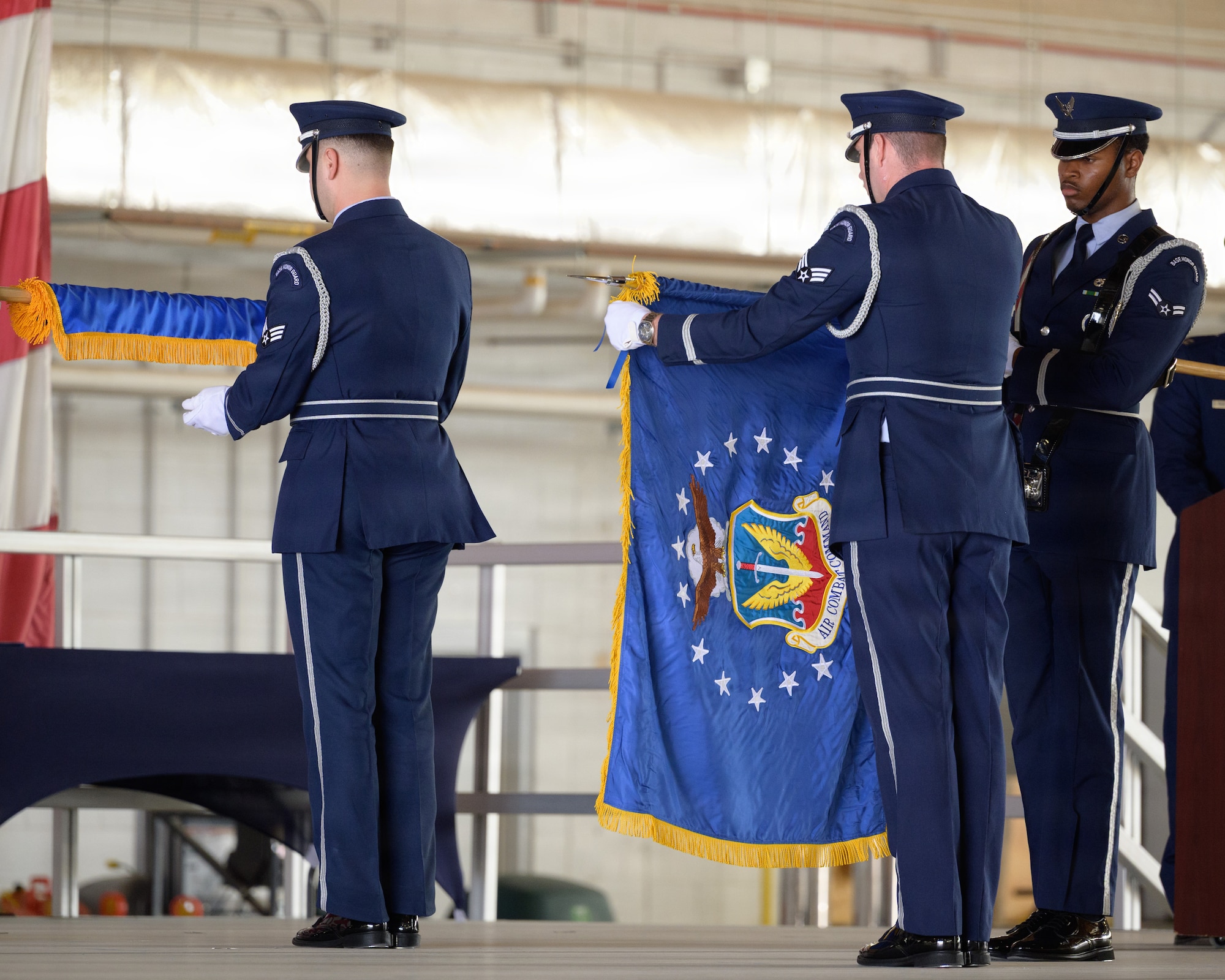 The Air Combat Command flag is unfurled during the 49th Wing change of command and major command reassignment ceremony at Holloman Air Force Base, New Mexico, June 4, 2026. The 49th Wing has been reassigned to ACC, optimizing training pipelines for Airmen at the primary F-16 Fighting Falcon and MQ-9 Reaper schoolhouse in the Air Force. (U.S. Air Force photo by Senior Airman Bob Teichmann)