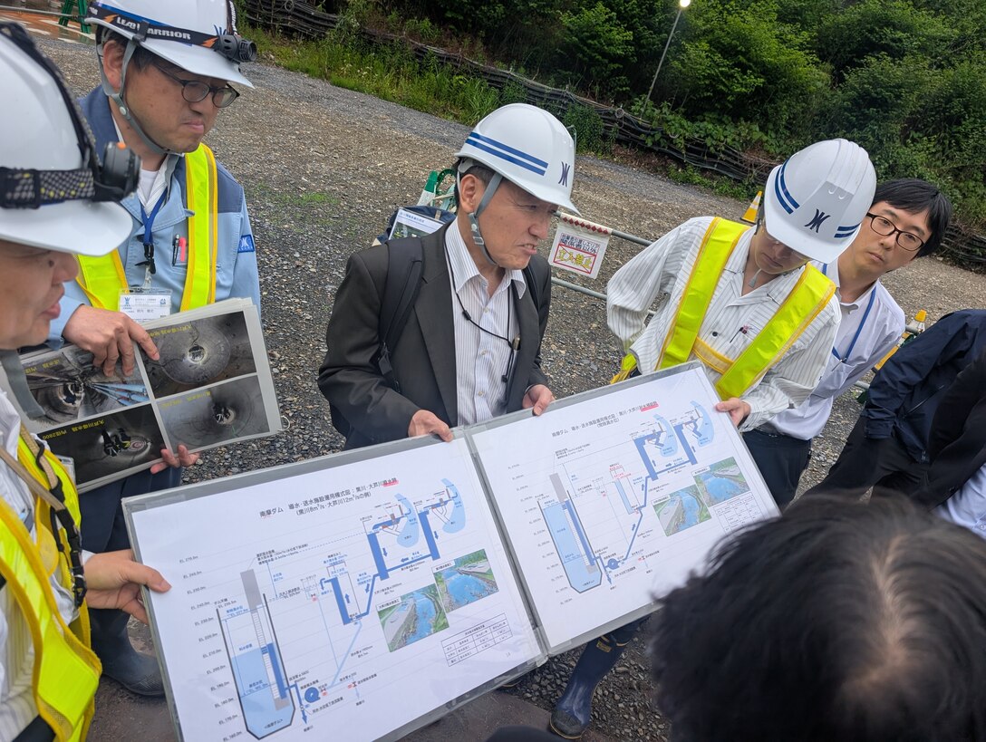 Japanese engineers discussing water resource challenges
