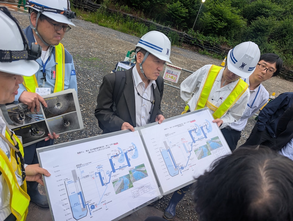 Japanese engineers discussing water resource challenges