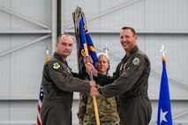 outgoing commander gives back guidon