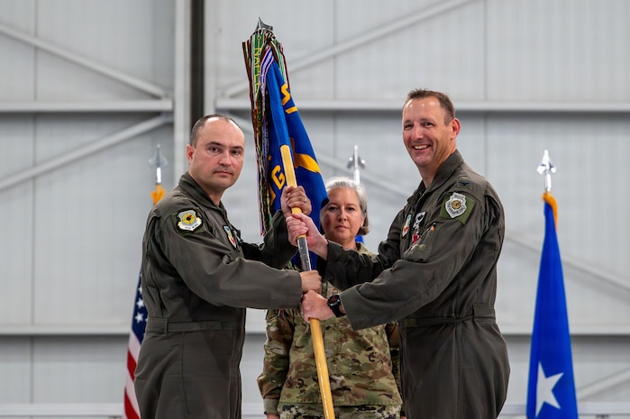 outgoing commander gives back guidon