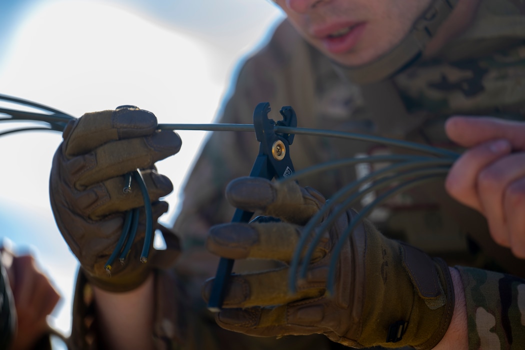 Airman 1st Class Gabriel Kendle, 354th Civil Engineer Squadron explosive ordnance disposal team member, cuts a set of detonating cords during an Agile Moose drill at Eielson Air Force Base, Alaska, May 28, 2026.