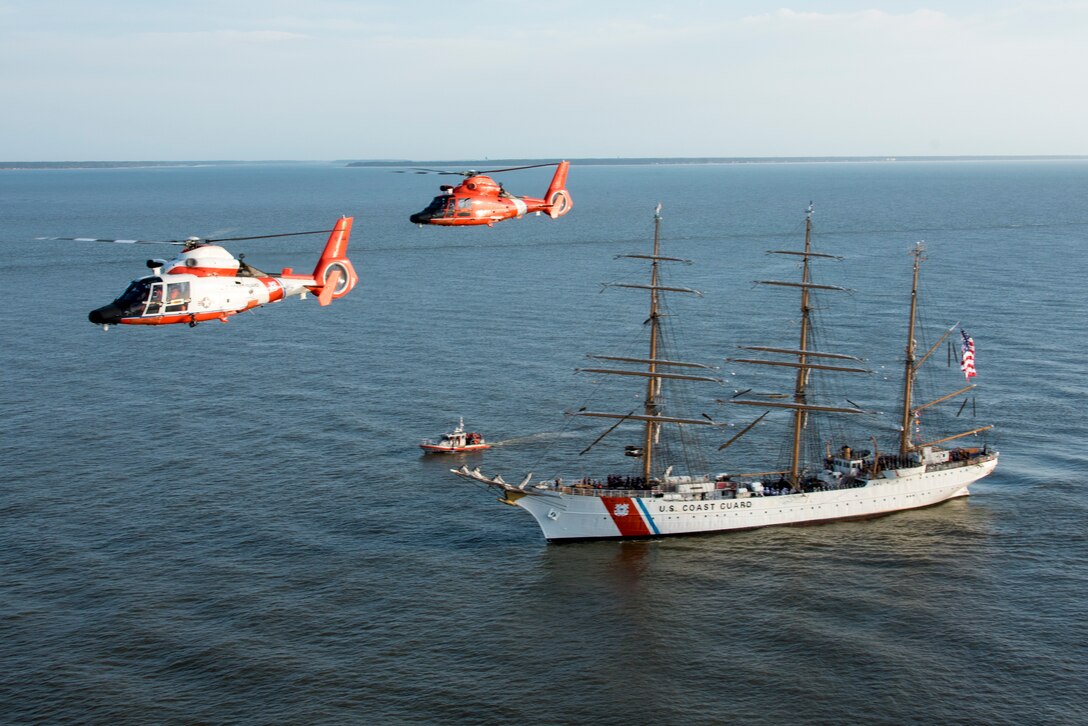 Two Coast Guard Air Station Savannah MH-65 Dolphin helicopters fly in formation March. 15, 2019, as the Cutter Eagle transits down the Savannah River towards Savannah, Georgia. Air Station Savannah welcomed the Eagle crew as they arrived in Savannah for St. Patrick’s Day weekend. (U.S. Coast Guard photo by Petty Officer 3rd Class Ryan Dickinson)