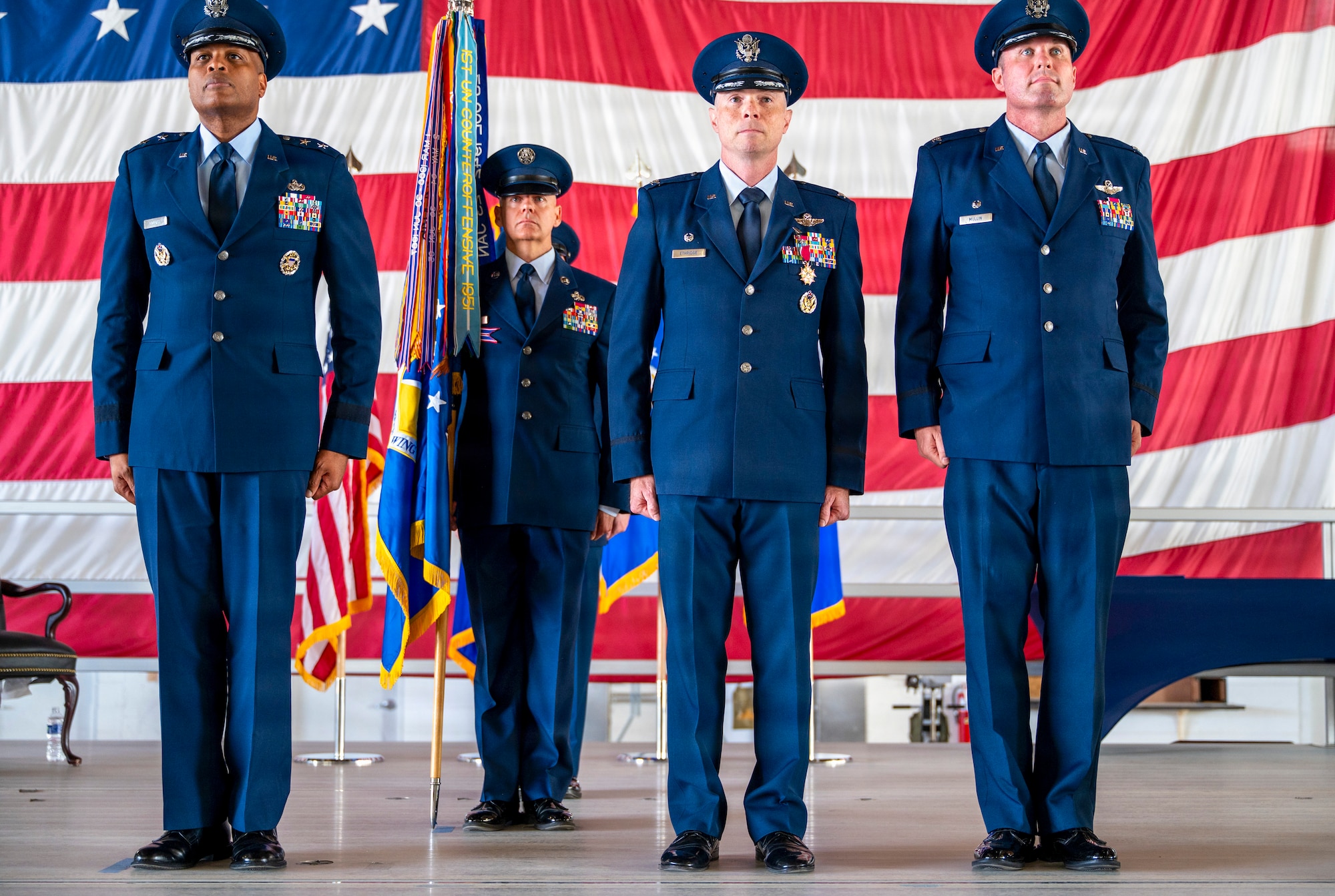 U.S. Air Force leaders stand at attention during a change of command and major command reassignment ceremony at Holloman Air Force Base, New Mexico, June 4, 2026. The ceremony marked the 49th Wing's transition from Air Education and Training Command to Air Combat Command and the assumption of command by Col. Michael S. Mullin. (U.S. Air Force photo by Senior Airman Michelle Ferrari)
