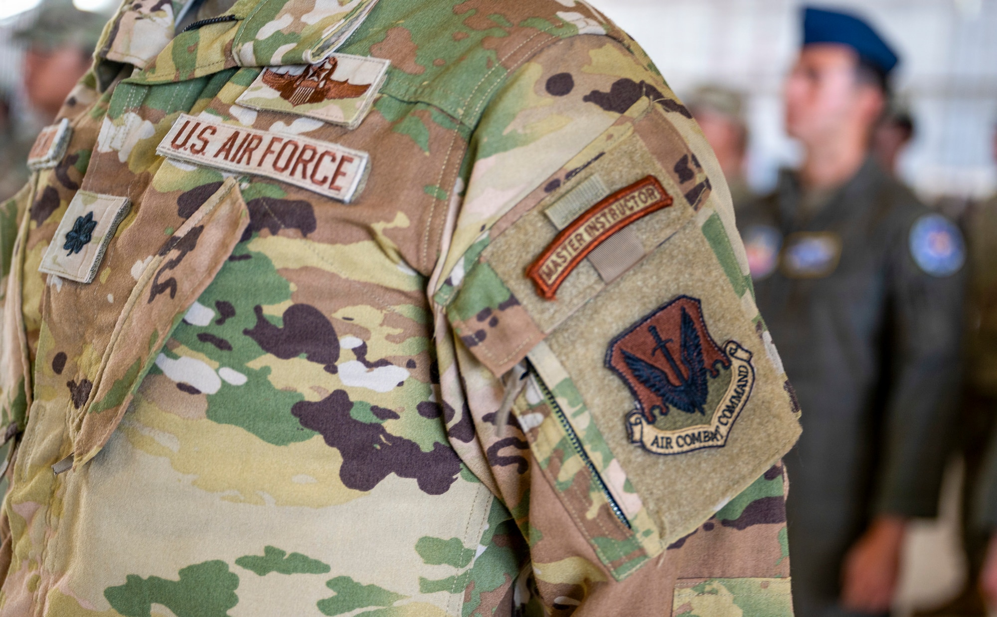 An Air Combat Command patch is displayed on a U.S. Air Force Airman's uniform during a change of command and major command reassignment ceremony at Holloman Air Force Base, New Mexico, June 4, 2026. The 49th Wing officially transitioned from Air Education and Training Command to Air Combat Command during the ceremony, marking a historic shift in the wing's alignment and mission focus. (U.S. Air Force photo by Senior Airman Michelle Ferrari)