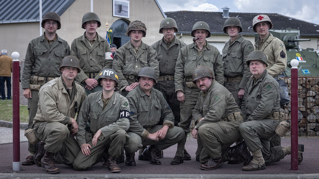 Reenactors pose for a photo during a D-Day 82 Memorial Ceremony, Quinéville, Normandy, June 05, 2026. The event memorialized the sacrifices of 4th Infantry Division Soldiers during the D-Day landings to liberate Europe from Nazi occupation. (U.S. Army photo by Sgt. William Rogers)