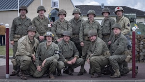 Reenactors pose for a photo during a D-Day 82 Memorial Ceremony, Quinéville, Normandy, June 05, 2026. The event memorialized the sacrifices of 4th Infantry Division Soldiers during the D-Day landings to liberate Europe from Nazi occupation. (U.S. Army photo by Sgt. William Rogers)