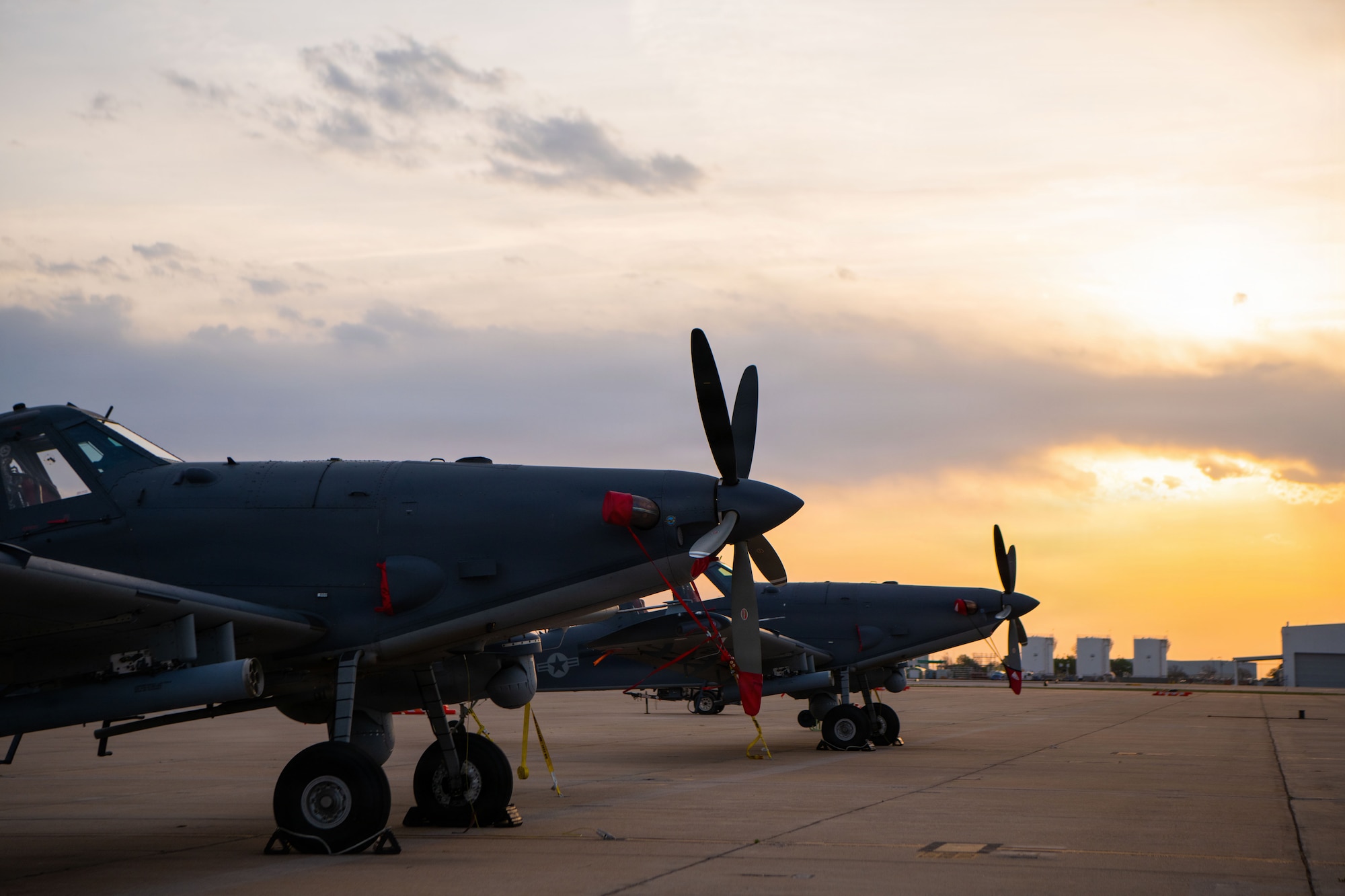 A military aircraft sits on the flightline.