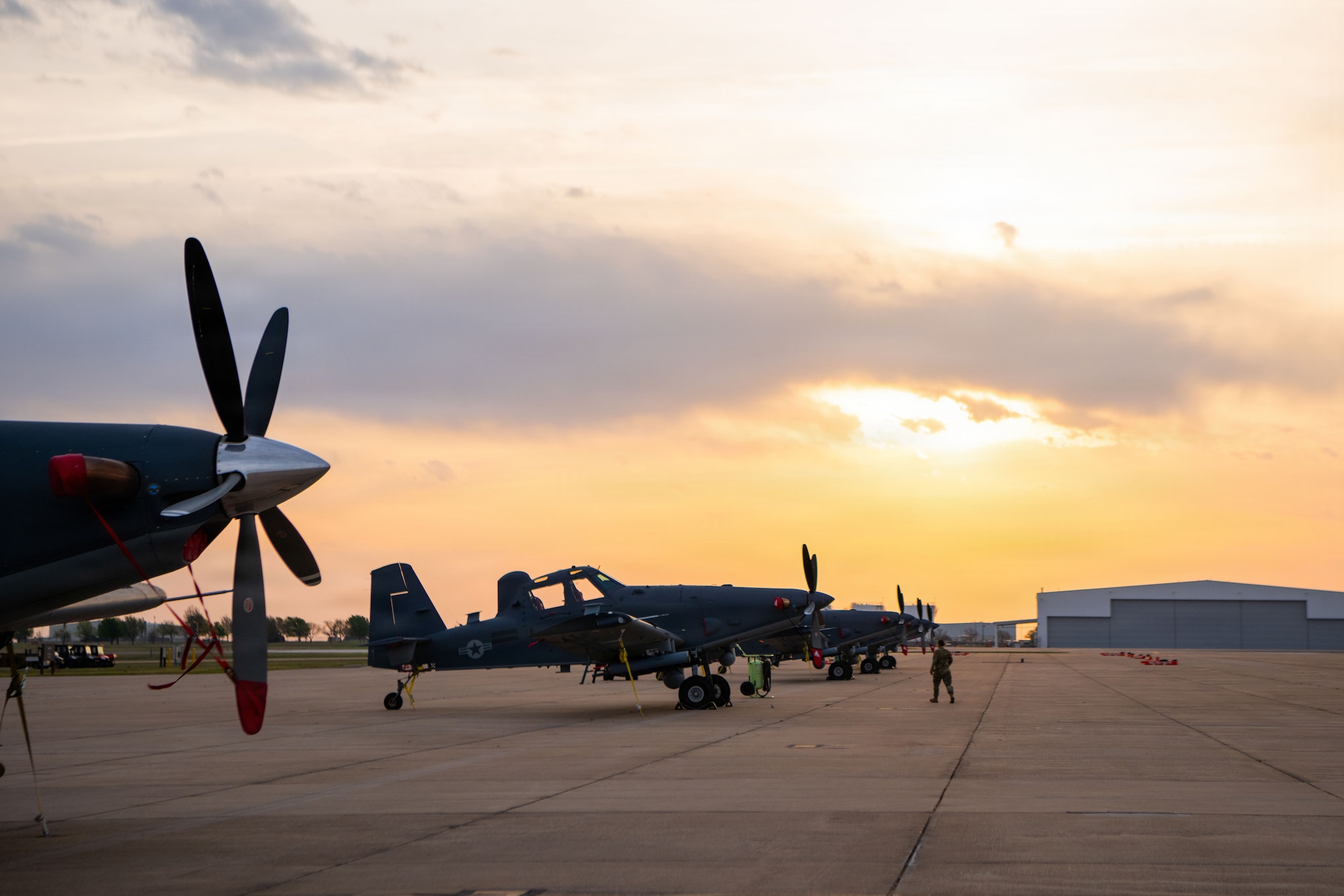 A military aircraft sits on the flightline.