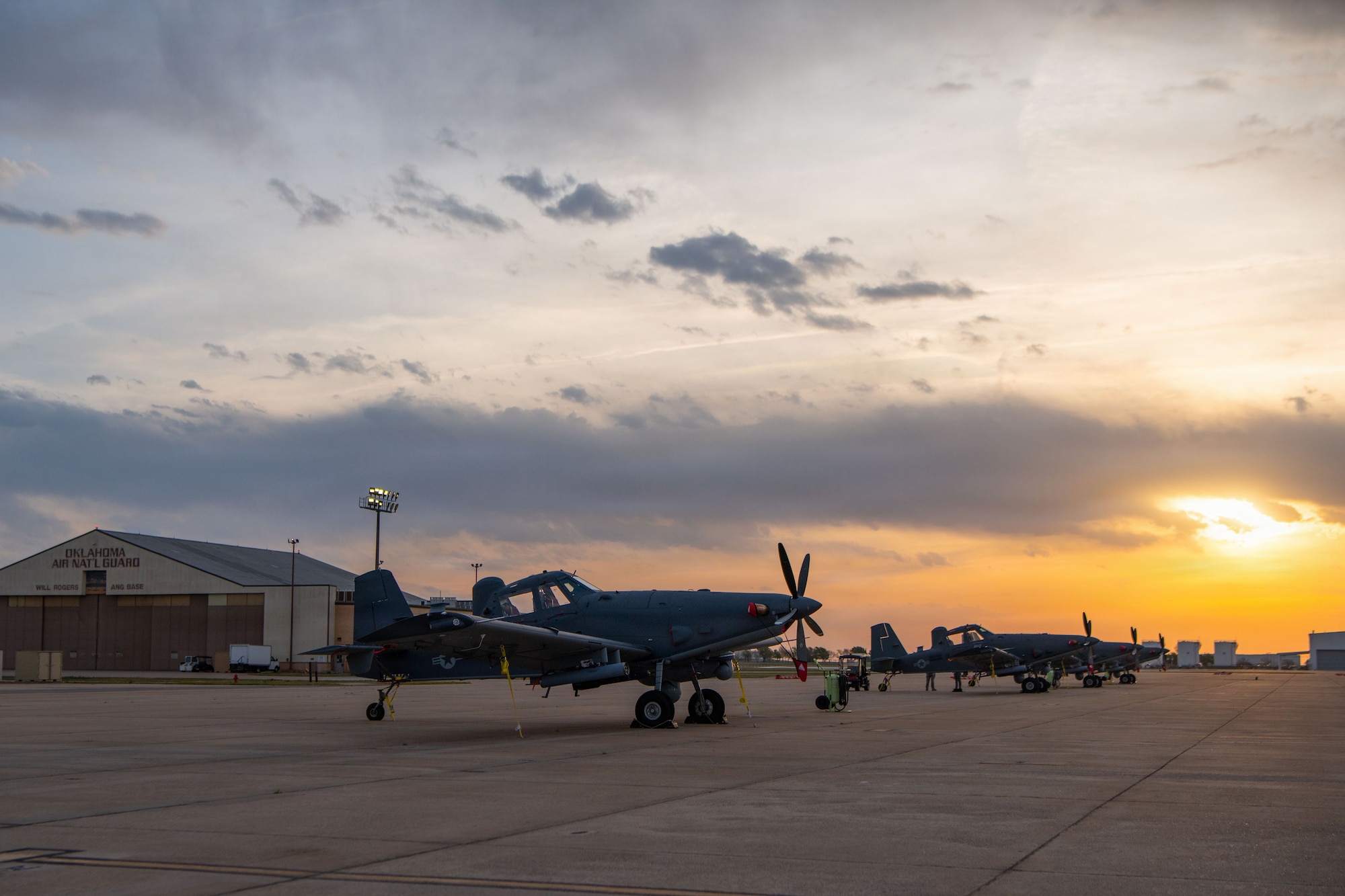 A military aircraft sits on the flightline.