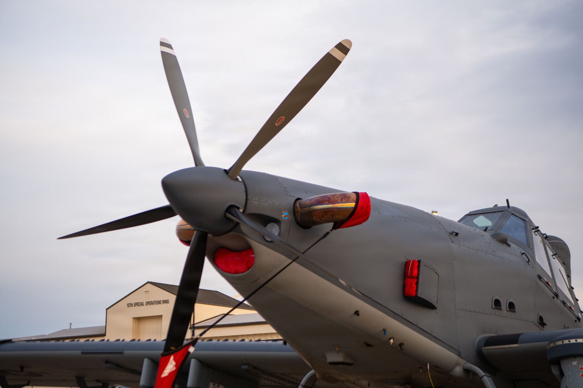 A military aircraft sits on the flightline.