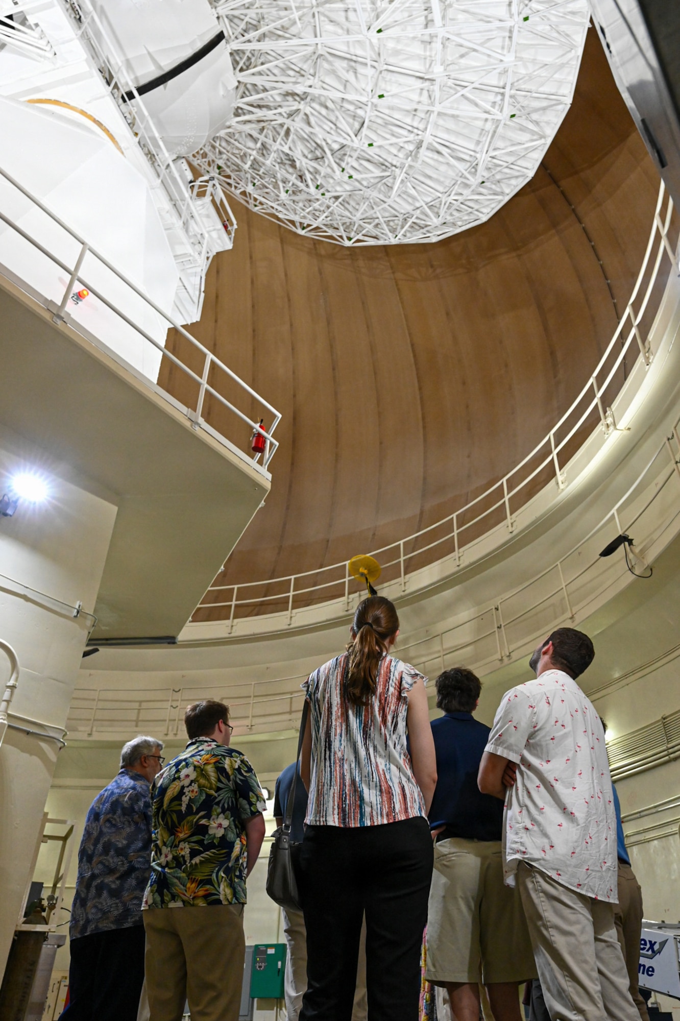 Participants from the Mississippi College tour group look up at a radar antenna contained within a radar dome.