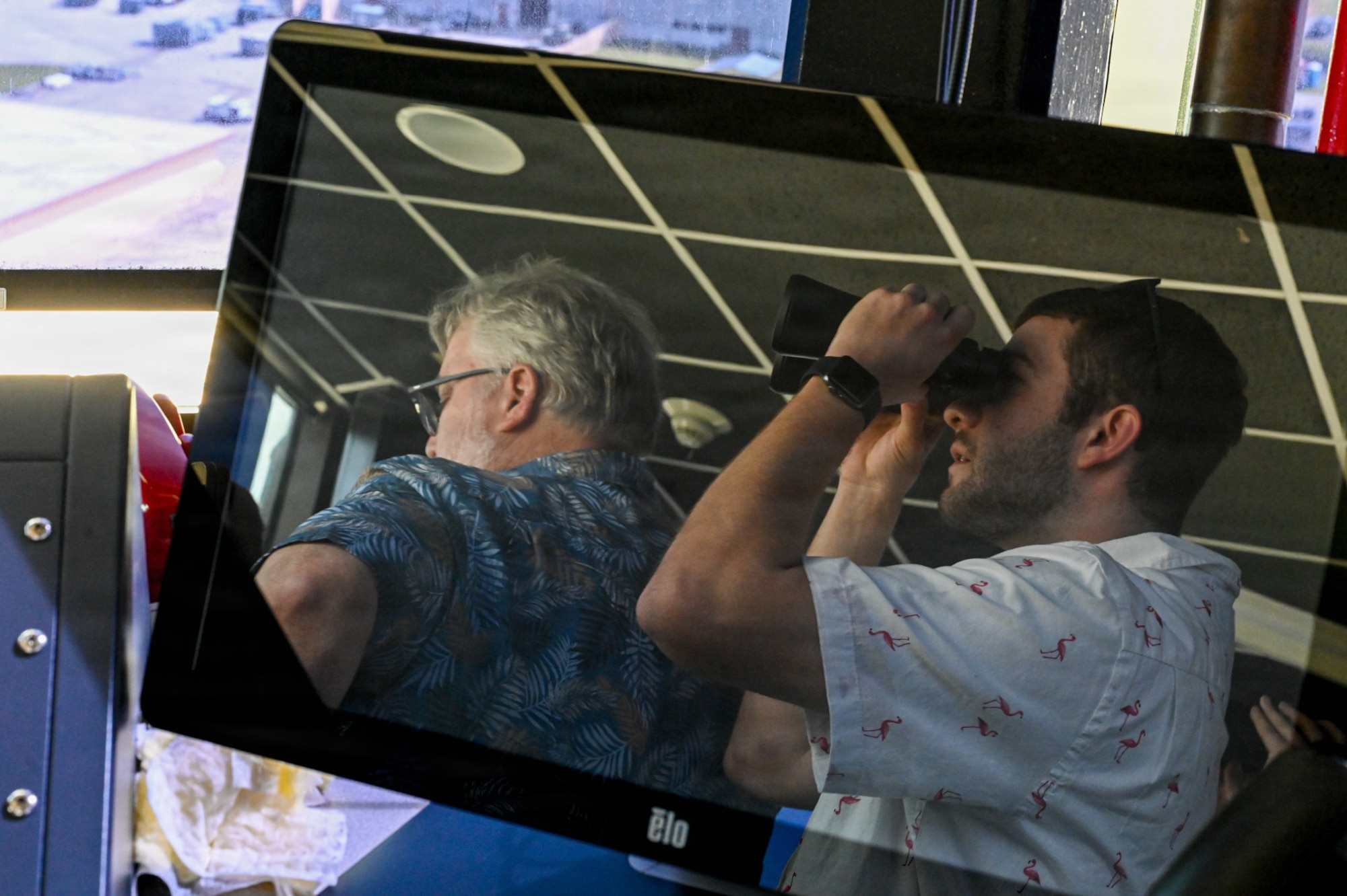 Dr. William Morehead, left, an instructor at Mississippi College, and Ryan Brown, right, a student at Mississippi College, observe flightline operations.