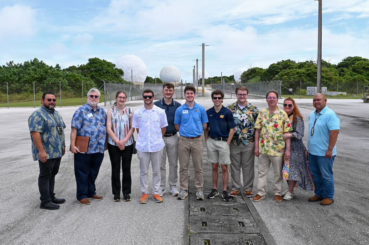 Students and faculty from the Mississippi College tour group pose for a group photo in front of radar domes at the Guam Tracking Station.