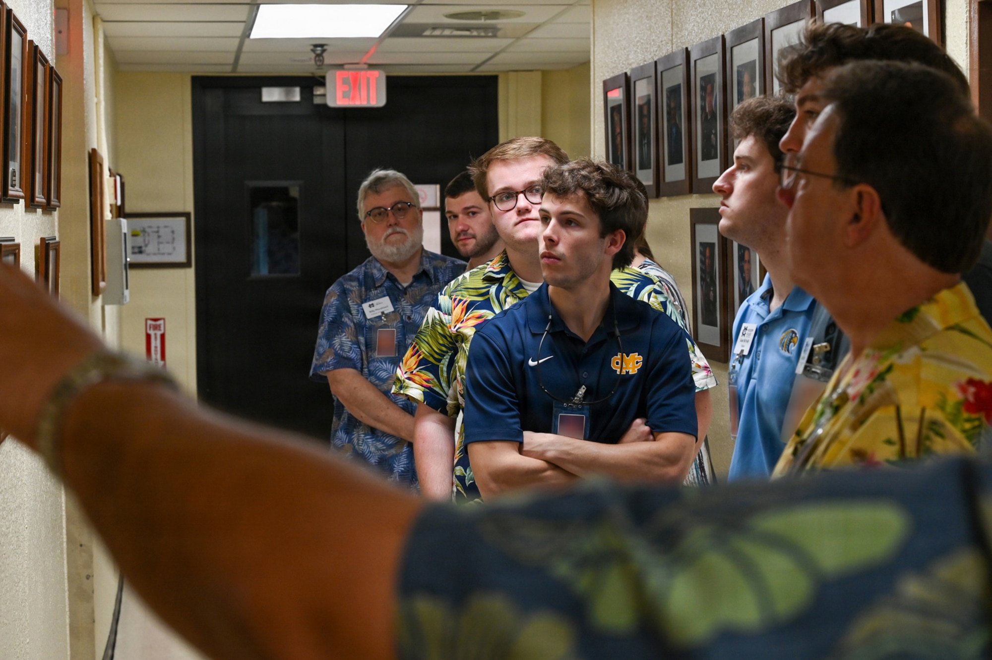 Participants from the Mississippi College tour group view a historical photo display on their stop at the Guam Tracking Station.