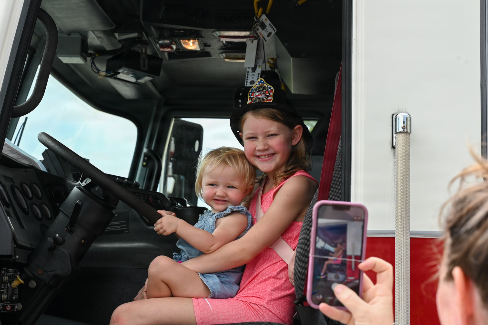 Military home school students pose for a photo in a fire truck.