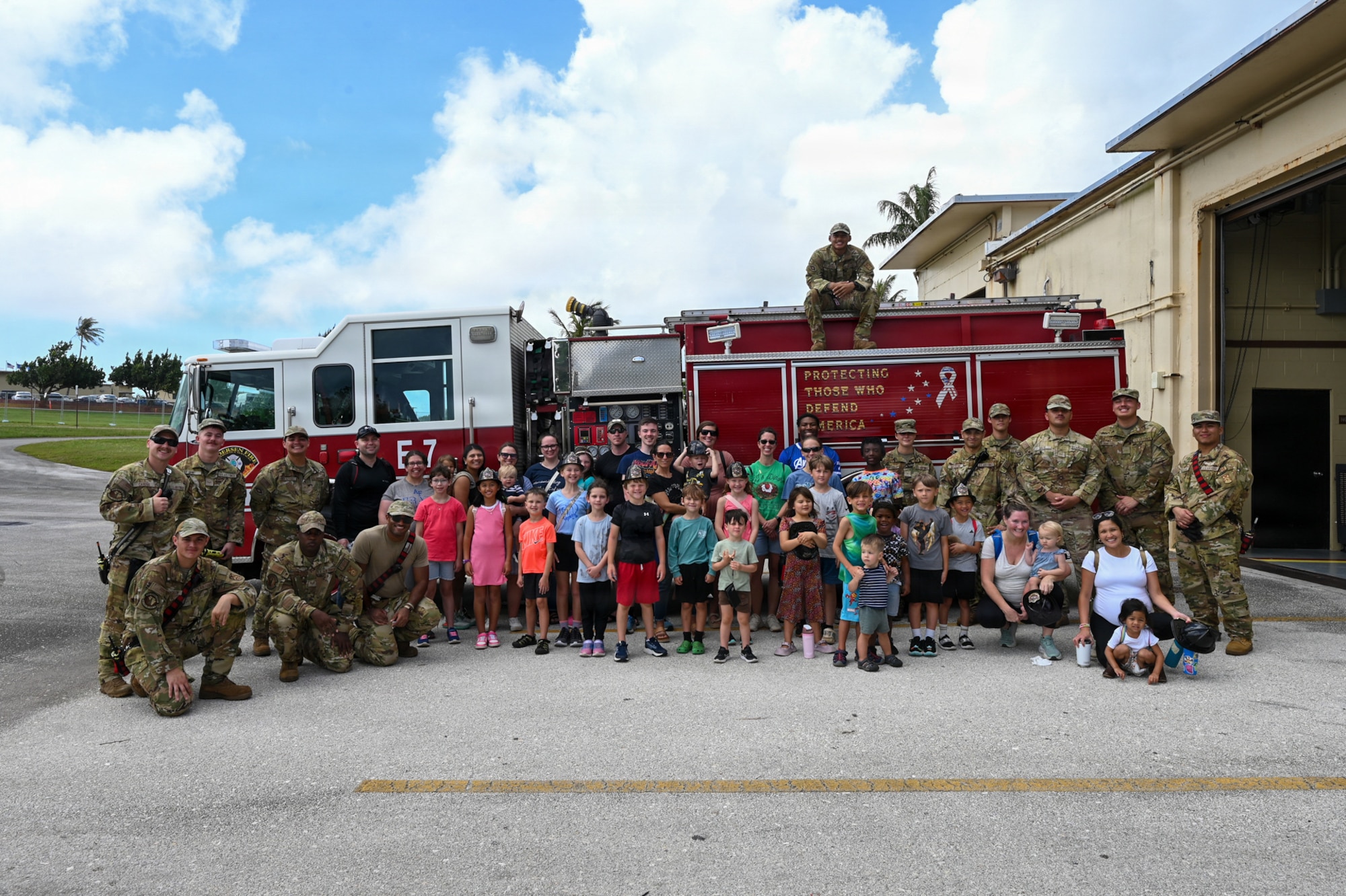 Parents and students from the military home school base tour group pose for a group photo with airmen from the 36th Civil Engineer Squadron.