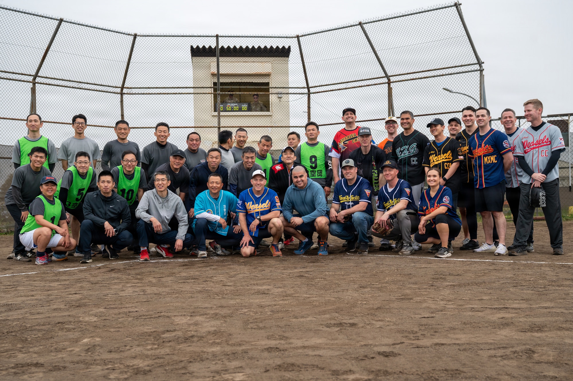 U.S. military and Japan Air Self-Defense Force participants pose for a group photo following a softball game during the 2026 Sakura Olympics