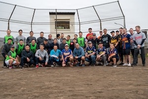 U.S. military and Japan Air Self-Defense Force participants pose for a group photo following a softball game during the 2026 Sakura Olympics