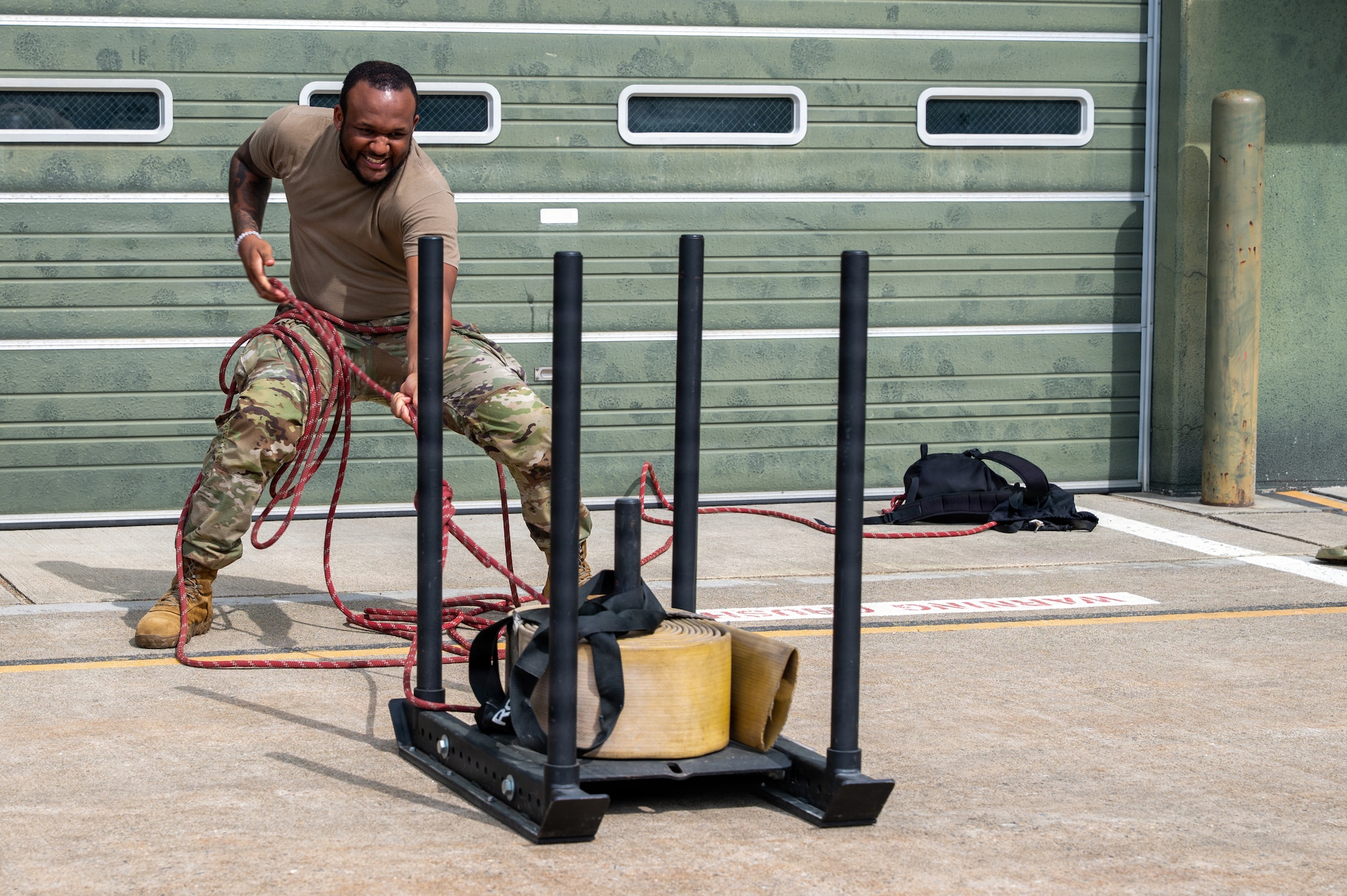 U.S. Air Force Senior Airman Canon Moore, 35th Medical Group records management technician, pulls a weighted sled during a firefighter challenge as part of the Wild Weasel immersion tour