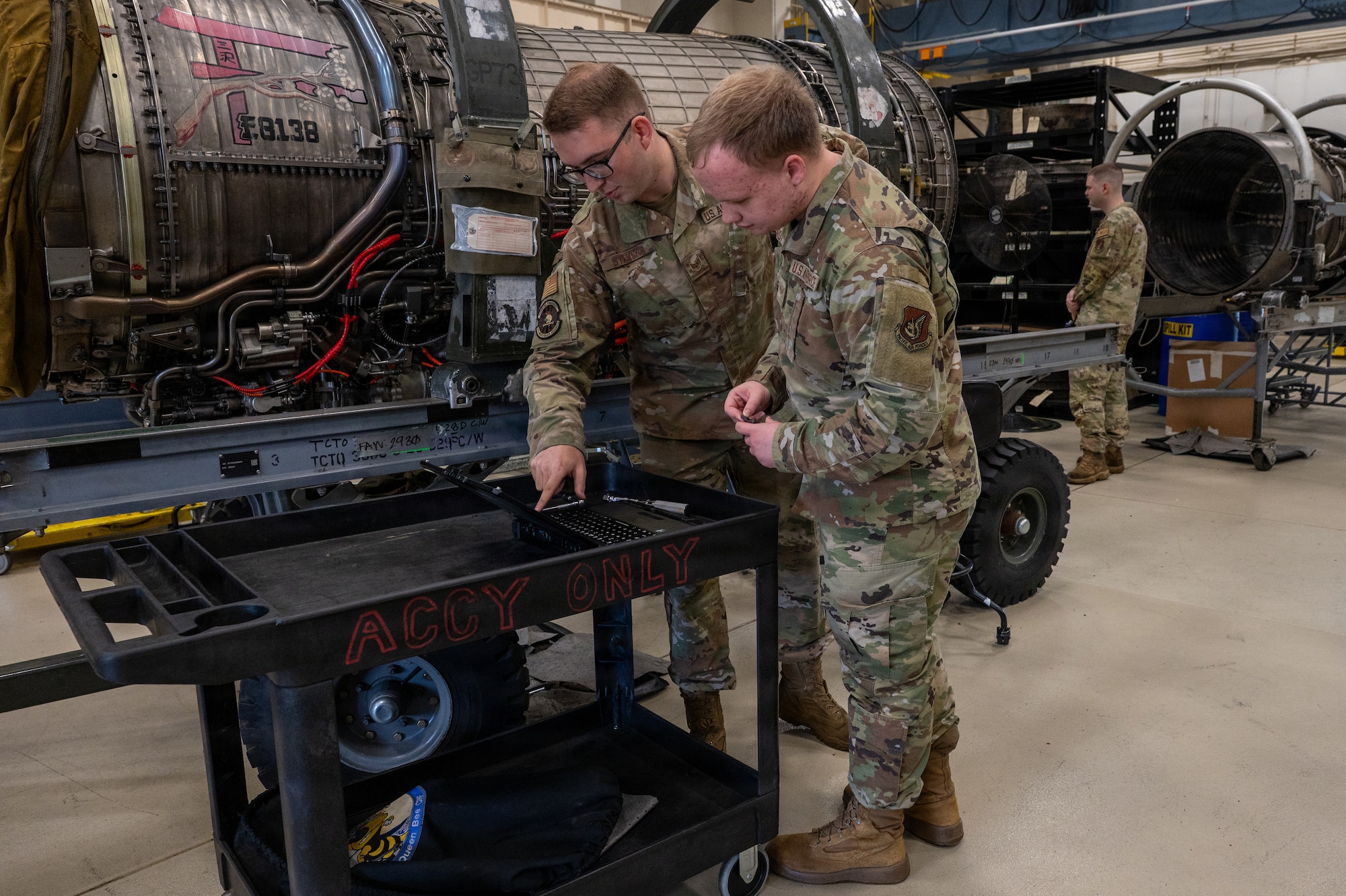 U.S. Air Force Staff Sgt. Justin Stevens, 35th Maintenance Squadron centralized repair facility dock chief, explains propulsion maintenance processes to Senior Airman Nathan Pardy, 35th Operations Support Squadron all-source intelligence analyst, during a Wild Weasel immersion tour