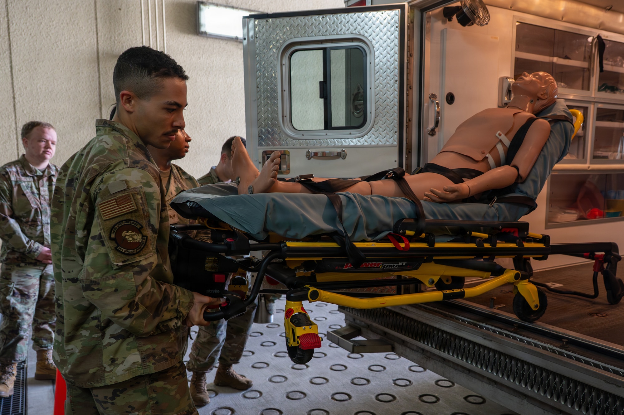U.S. Air Force 1st Lt. Nigel West, 35th Surgical Operations Squadron clinical nurse, assists with a patient transport training scenario during a Wild Weasel immersion tour