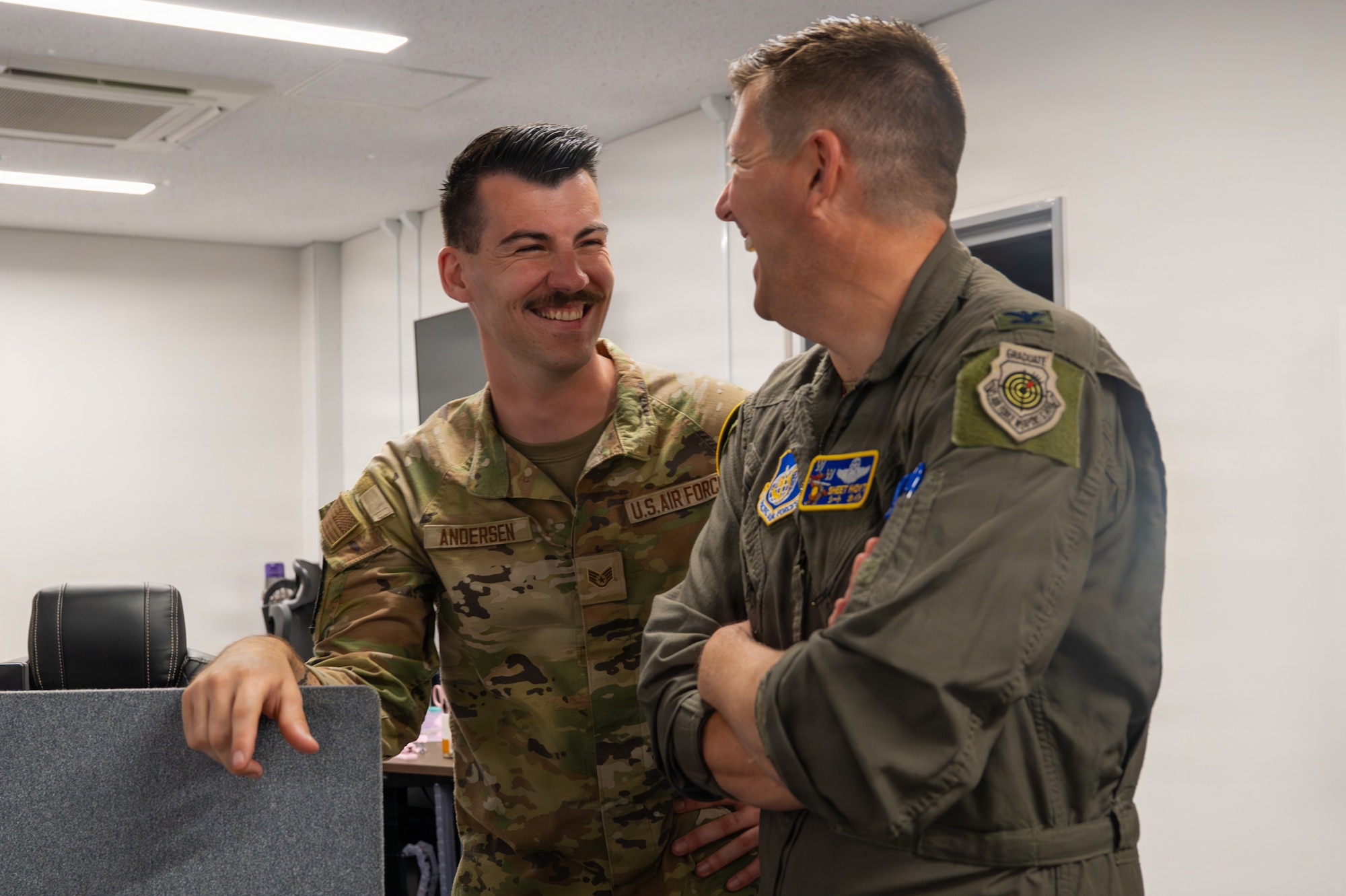 U.S. Air Force Staff Sgt. Daniel Andersen, left, 13th Fighter Squadron intelligence noncommissioned officer in charge, speaks with Col. Matthew Hoyt, 35th Fighter Wing deputy commander, during a Wild Weasel walk-through