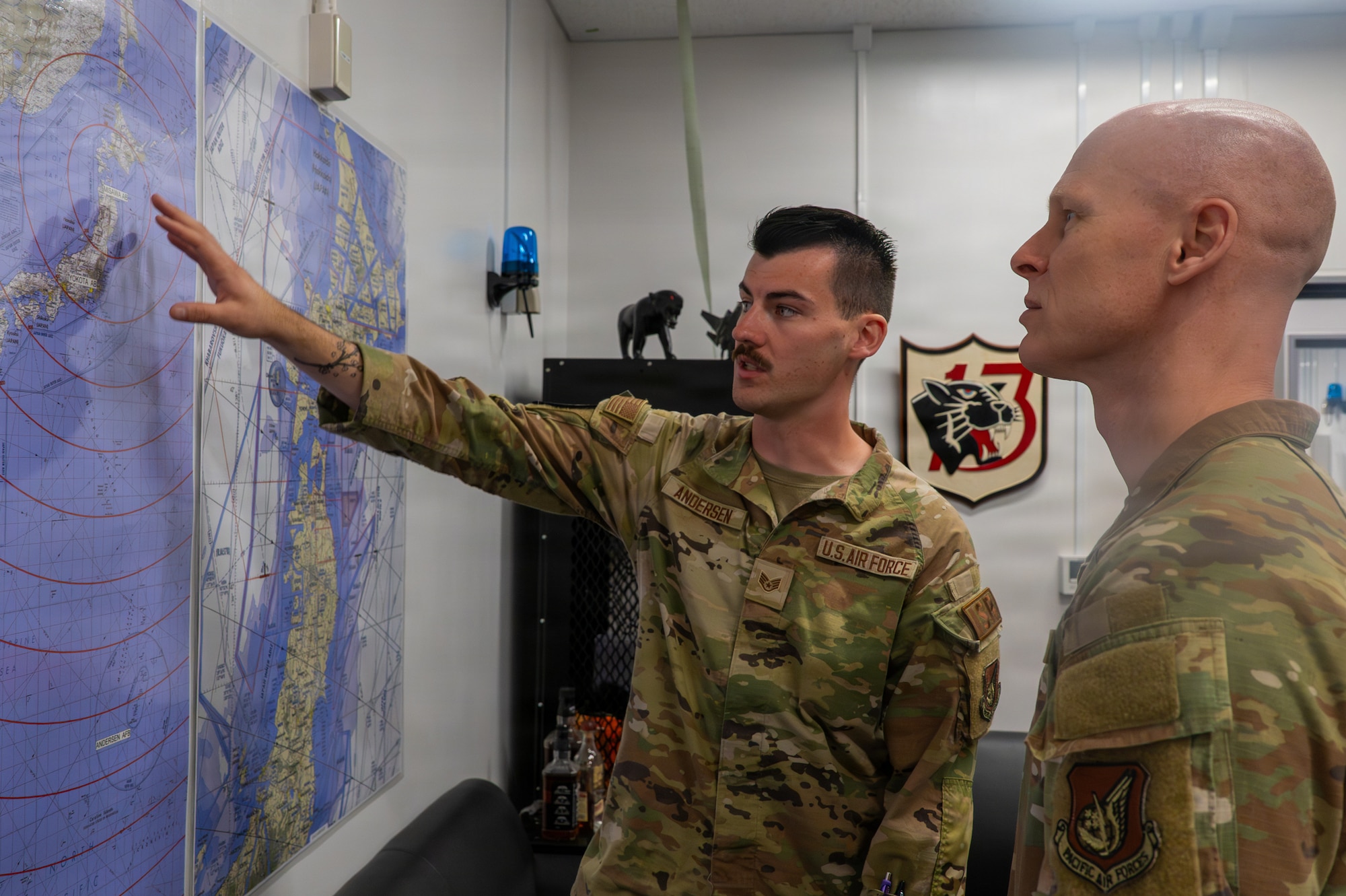 U.S. Air Force Staff Sgt. Daniel Andersen, 13th Fighter Squadron intelligence noncommissioned officer in charge, explains his roles within intelligence operations to Chief Master Sgt. Leonard Myers, 35th Medical Group senior enlisted leader, during a Wild Weasel Walk-Through