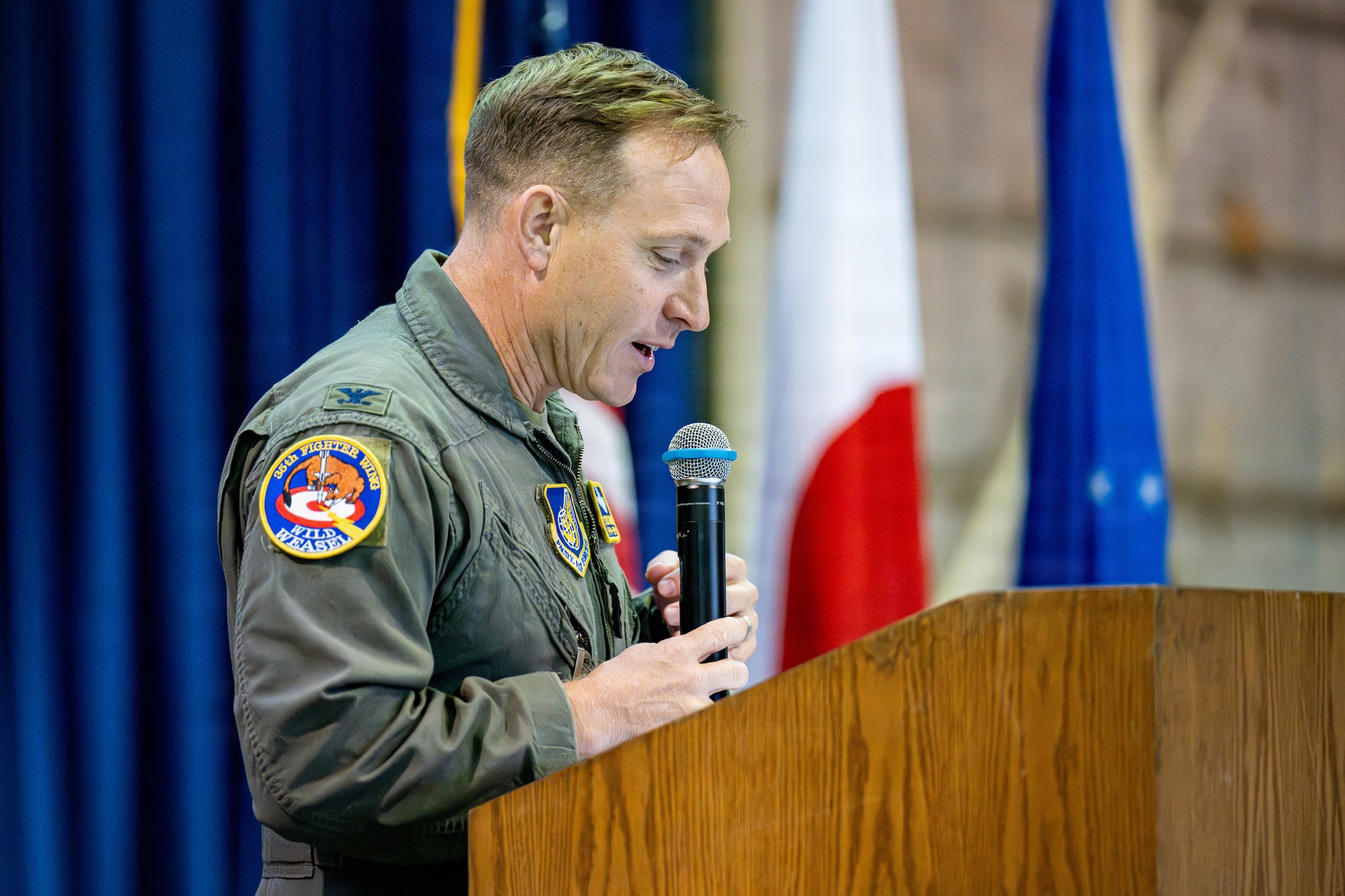 U.S. Air Force Col. Paul Davidson, 35th Fighter Wing commander, gives a speech on the accomplishments of Col. Winton Laslie, outgoing 35th Medical Group commander, during a change of command ceremony.