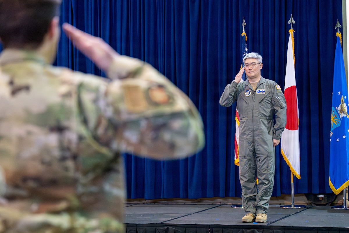 U.S. Air Force Col. James Choi, incoming 35th Medical Group commander, renders his first salute to 35th MDG members during a change of command ceremony.