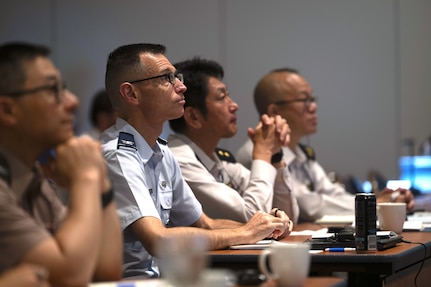 U.S. Air Force Col. David Bargatze, U.S. Forces Japan staff judge advocate, with representatives from the Tri-Command Judge Advocate’s Office and Japan Ground Self-Defense Force listen during a briefing at the 2026 Northeast Asia International and Operational Law Conference May 19, 2026 at the New Sanno Hotel in Tokyo, Japan.