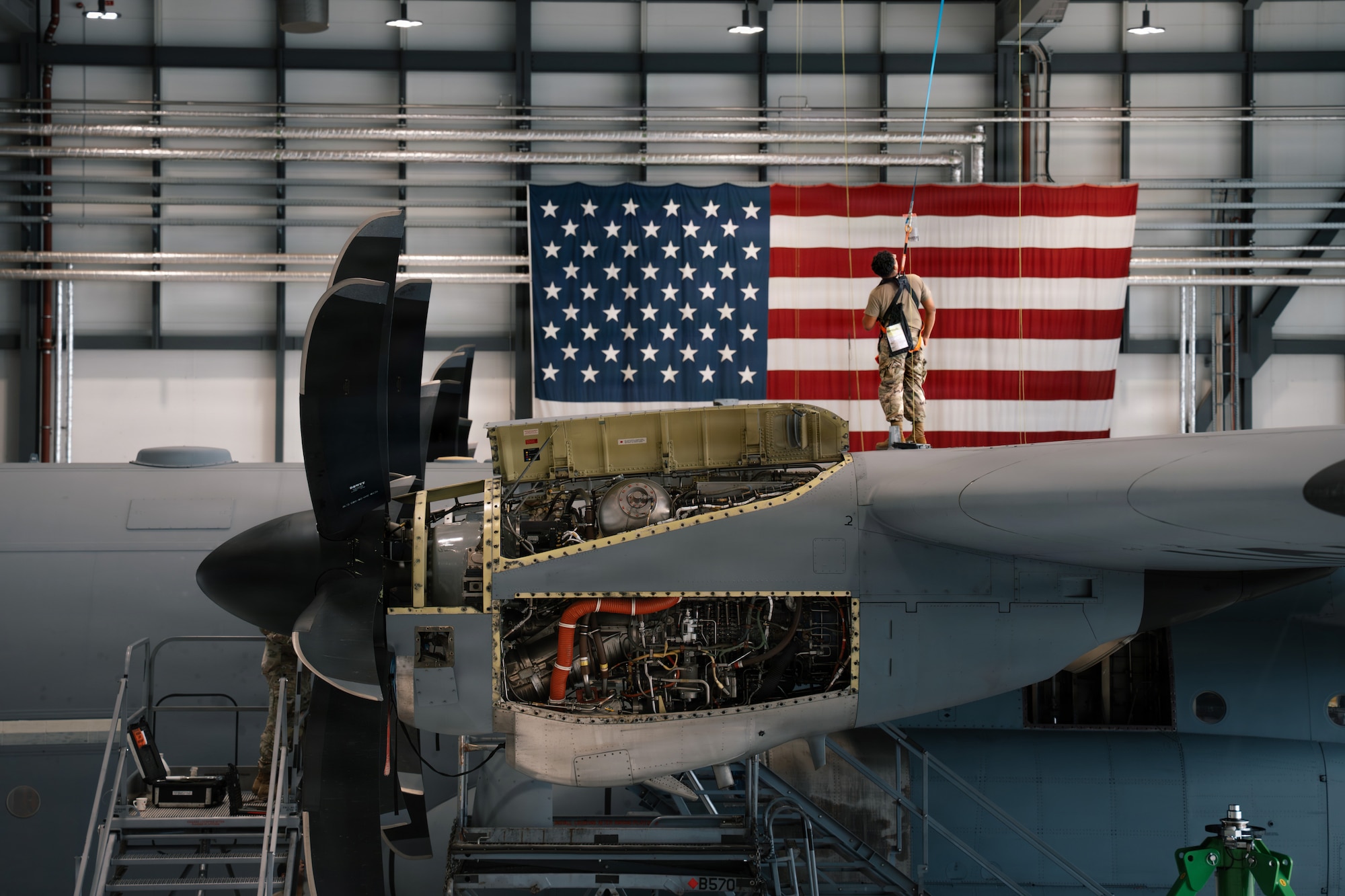 U.S. Air Force Airman 1st Class Jose Galindo-Barrios, 86th Maintenance Squadron aircraft electrical and environmental journeyman, is harnessed to the top of a C-130J Super Hercules to conduct letter-check repairs at Ramstein Air Base, Germany, June 3, 2026.