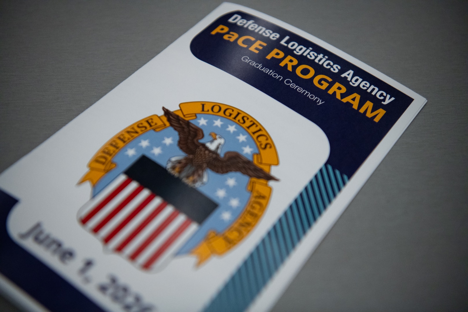 A program for a ceremony that reads, "Defense Logistics Agency PACE Program Graduation Ceremony, June 1, 2026"