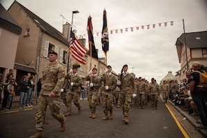 Paratroopers assigned to the 82nd Airborne Division march through the streets during the Grande Parade in Sainte Mere Eglise, France on June 05, 2025. The legacy of D-Day lives in our commitment to freedom, in our unity as nations, and in our determination to build a better future. (U.S. Army photo by Sgt. Noe Cork)