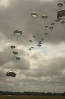 Paratroopers from Allied forces jump onto the drop zone at La Fiere, France, June 07, 2026. D-Day 82 commemorates the courage and sacrifice of Allied forces who fought for freedom, reminding us of the enduring strength of alliances and shared responsibility. (U.S. Army photo by Sgt. Noe Cork)