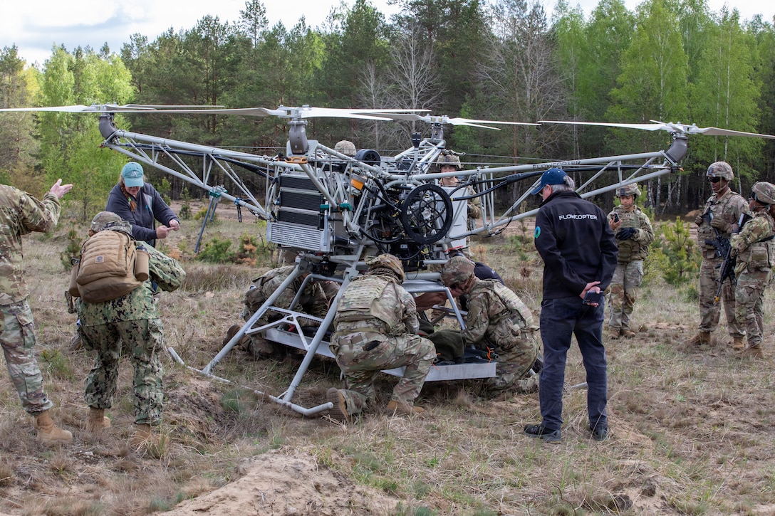 U.S. Army Soldiers assigned to the Regimental Support Squadron, 2d Cavalry Regiment, strap down a test dummy to a drone during an Autonomous Triage and Treatment Challenge taking place near Bemowo Piskie Training Area, Poland, May 10, 2026. From April 27 to May 31, 2026, U.S. and Allied forces will exercise the North Atlantic Treaty Organization’s (NATO) Eastern Flank Deterrence Initiative, demonstrating NATO’s ability to fight and win on the modern battlefield. Nearly 15,000 troops from eleven nations will train across the High North, Baltic region, and Poland. They will execute rapid maneuvers, air defense, counter-drone operations, and cyber defense to validate NATO’s regional defense plans in real time. This series of linked exercises includes Saber Strike, Immediate Response, and Swift Response. The exercises turn investment into capability. Soldiers integrate unmanned systems such as AI-enabled command and control and live data networks to move, decide, and fight more effectively across all domains. Sword 26 demonstrates how U.S. Army Europe and Africa drives transformation at scale while strengthening deterrence. Together with our allies, we are building a unified, lethal force ready to defend NATO territory and respond to any threat. (U.S. Army Reserve photo by Spc. Thomas Madrzak)
