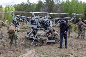 U.S. Army Soldiers assigned to the Regimental Support Squadron, 2d Cavalry Regiment, strap down a test dummy to a drone during an Autonomous Triage and Treatment Challenge taking place near Bemowo Piskie Training Area, Poland, May 10, 2026. From April 27 to May 31, 2026, U.S. and Allied forces will exercise the North Atlantic Treaty Organization’s (NATO) Eastern Flank Deterrence Initiative, demonstrating NATO’s ability to fight and win on the modern battlefield. Nearly 15,000 troops from eleven nations will train across the High North, Baltic region, and Poland. They will execute rapid maneuvers, air defense, counter-drone operations, and cyber defense to validate NATO’s regional defense plans in real time. This series of linked exercises includes Saber Strike, Immediate Response, and Swift Response. The exercises turn investment into capability. Soldiers integrate unmanned systems such as AI-enabled command and control and live data networks to move, decide, and fight more effectively across all domains. Sword 26 demonstrates how U.S. Army Europe and Africa drives transformation at scale while strengthening deterrence. Together with our allies, we are building a unified, lethal force ready to defend NATO territory and respond to any threat. (U.S. Army Reserve photo by Spc. Thomas Madrzak)