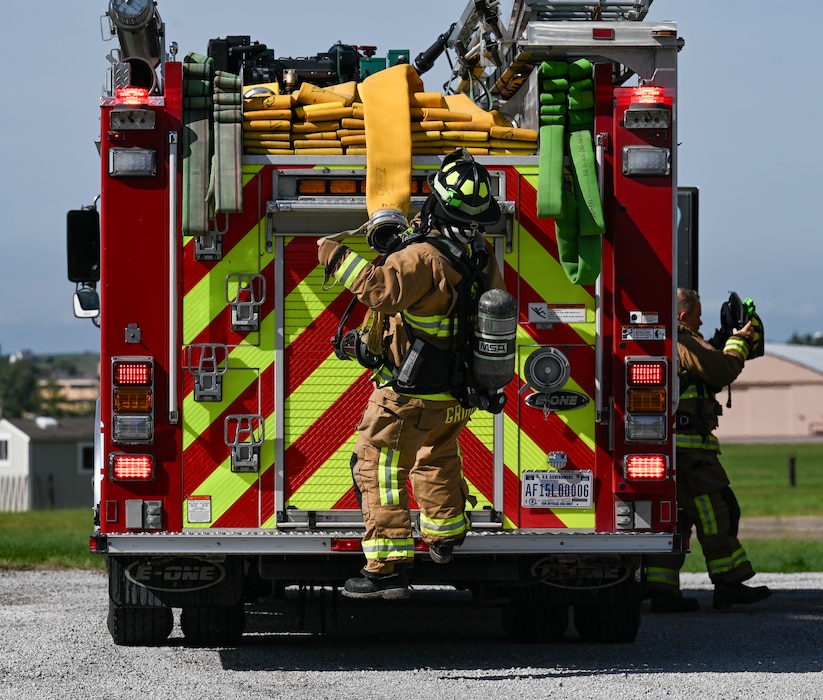 U.S. Air Force Firefighters from the 55th Civil Engineering Squadron prepare the hose to put out fire during Major Accident Response Exercise on Offutt Air Force Base, Nebraska, June 6, 2026. The exercise is used to simulate an aircraft crash in a real world scenario. (U.S. Air Force photo by Airman 1st Class Charles Bolden)