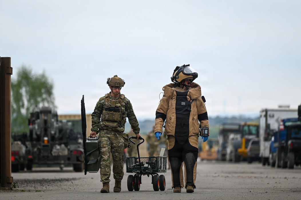 U.S. Air Force Senior Airman Cameron Poe, left, 786th Civil Engineer Squadron explosive ordnance disposal team member and Staff Sgt. Christian Brown, 786th CES EOD team leader, walk towards a simulated improvised explosive device