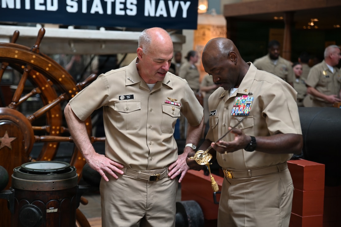 Vice Adm. Scott Gray, commander of Navy Installations Command, left, speaks with Command Master Chief Dennis Hathorn, command master chief of Naval Support Activity Washington, as he holds an M1852 Navy Officer's Sword during a ceremony at the National Museum of the United States Navy on the Washington Navy Yard, April 1, 2026.