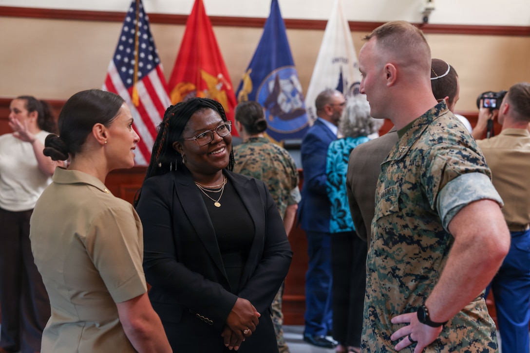 U.S. Marine Corps Maj. Chelsea Lucas, law program manager of Platoon Leaders Course, left, and Lon'Cherie' Billingsley, director of recruitment and employer development at North Carolina Central University School of Law, center, speak to Capt. Colin Norton, judge advocate for U.S. Navy-Marine Corps Court of Criminal Appeals, during the Educators Workshop Law Day at the Washington Navy Yard, Washington, D.C., on June 5, 2026. The experience helped educators better inform students about leadership and legal career opportunities within the Marine Corps. (U.S. Marine Corps photo by Cpl. Brenna Ritchie)